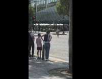 Woman red beret spin middle of street pictorial
