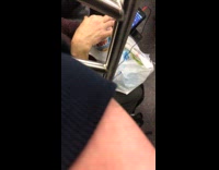 Person on subway train eating Skippy peanut butter with their finger