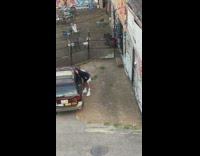 Guy pink beanie red car graffiti wall 