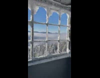 Girl looks out window mountain view snow 