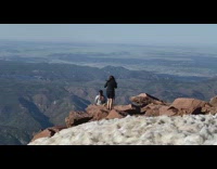 Woman backless jacket sit mountain top photo shoot