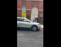 Man cowboy hat poses front of door