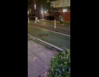 Man begging money with pole and cup chasing man