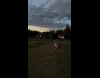 Man lay and roll down the grass hill