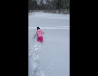 Little girl runs far away in deep snow and into tree 
