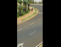 Man purple outfit dancing sidewalk