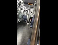 Guy white hat shirt and shoes dances and waves arms at the end of subway train car