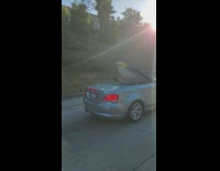 two surfboards silver bmw convertible car