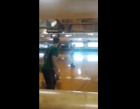 Guy in blue Nirvana shirt rollerskates in rink and falls on his butt