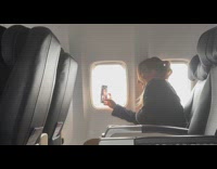 Woman selfie video with phone inside airplane