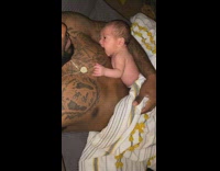 Baby sucks from dads nipple 