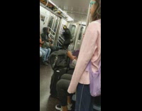 Guy yellow headphones dances and stomps feet on subway train