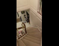 Guy hits orange ball down stairs cup 