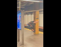 Collab WINY - Man striped print shirt bend over and hang on beam subway station