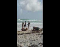 Bikini girl lays back with legs raised 