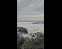 Woman surprised by strong wave 