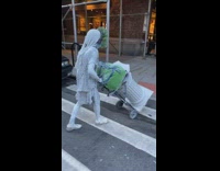 Street performer girl pushes dolly cart column 