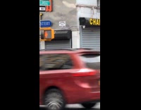Man sings and dances karaoke on sidewalk