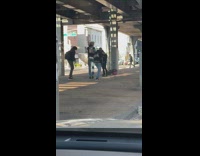 Guys holding guitars posing for video under bridge