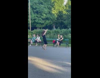 Woman in black dress tiktok dance at the park