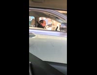 Guy hits drumsticks against steering wheel