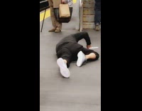 man black outfit on floor of station near stairs
