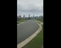 Guy skateboards down street falls off