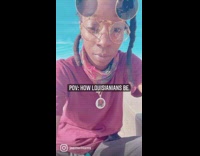 Woman eats crawfish by the river