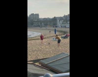 Red jacket girl poses beach sand guy 