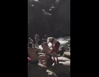 Red shorts guy front flips brown cliff 