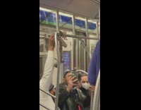 Man hang pet snake on train handrails
