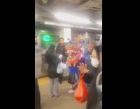 Group of People Carry Chinese Dragon in Subway