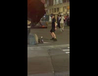 Man turns around and tiktok dance at the sidewalk