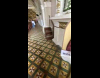 Woman shows holy water inside alcohol dispenser 