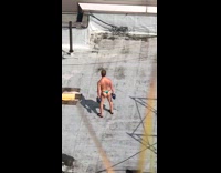 Guy blue thong speedo curls dumbbells rooftop 