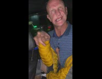 Bald guy in car makes weird faces 