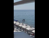 Woman ponytail bikini stand in beach water