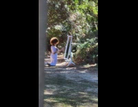 Woman takes a selfie with a mirror to reflect sunlight