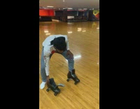 Guy pushes roller skate in circle rink 