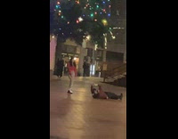Woman roll on the ground to take her friends picture
