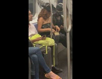 Woman and man in cowboy hats and clothing on subway train