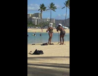 Woman in bikini with a Marshmello mask at the beach