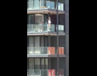 Woman tiktok dance outside the building balcony