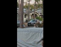 Woman in gray dress poses in the middle of the street