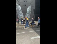 Girl poses with wall tall white wings