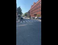 Guy balance tire on head while biking
