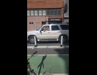 Man in escalade car plays the flute