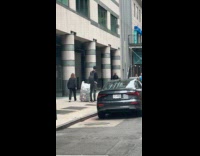 Man pees beside the bottles on sidewalk