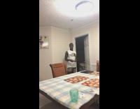 Guy throws playing card into green cup 