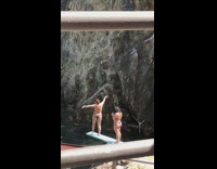 Bikini girl poses dances diving board lake 